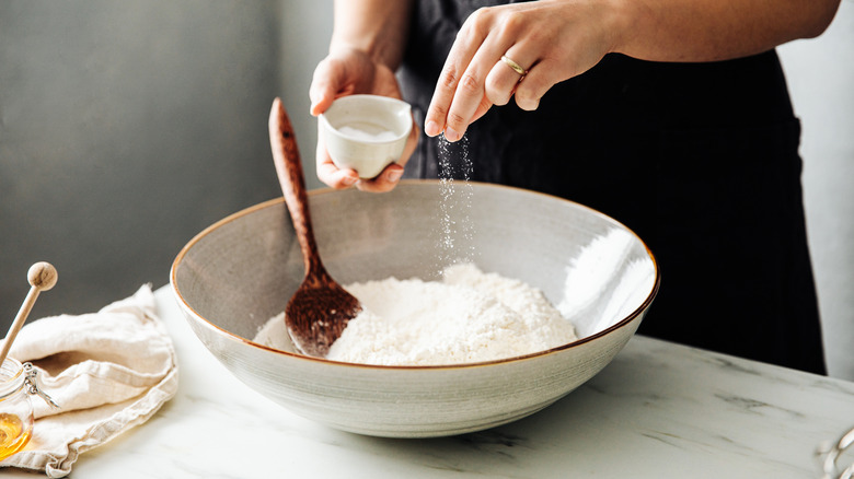 person baking with flour in a bowl