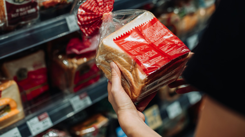 woman reading the back of packaged bread