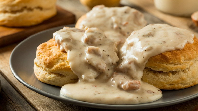 Biscuits and gravy on brown plate