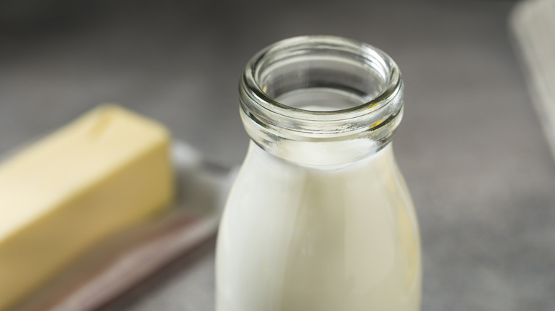 Jug of milk with butter in background