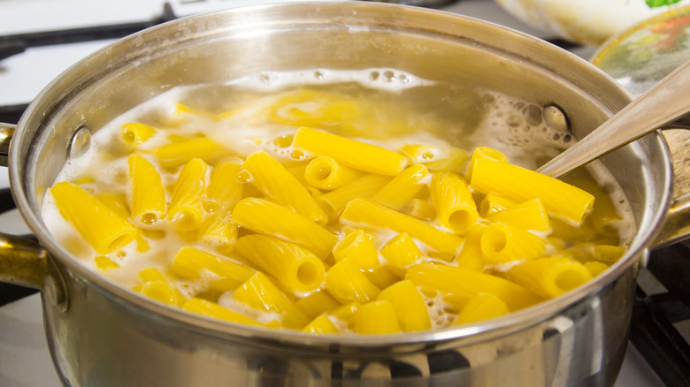 Rigatoni noodles boiling on stovetop