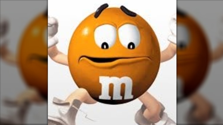 Nervous looking orange M&M's mascot