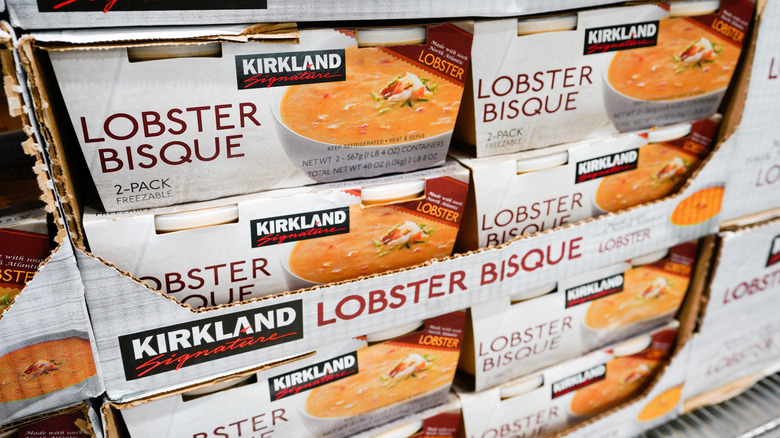 A stack of packages of Kirkland signature lobster bisque at Costco.