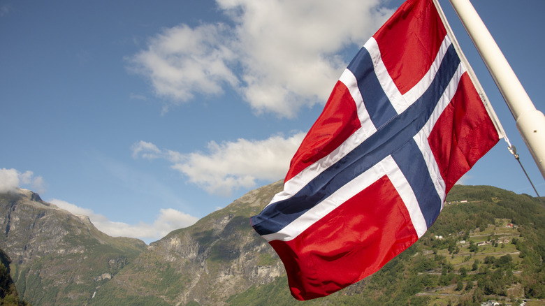 Norwegian flag with mountains in background