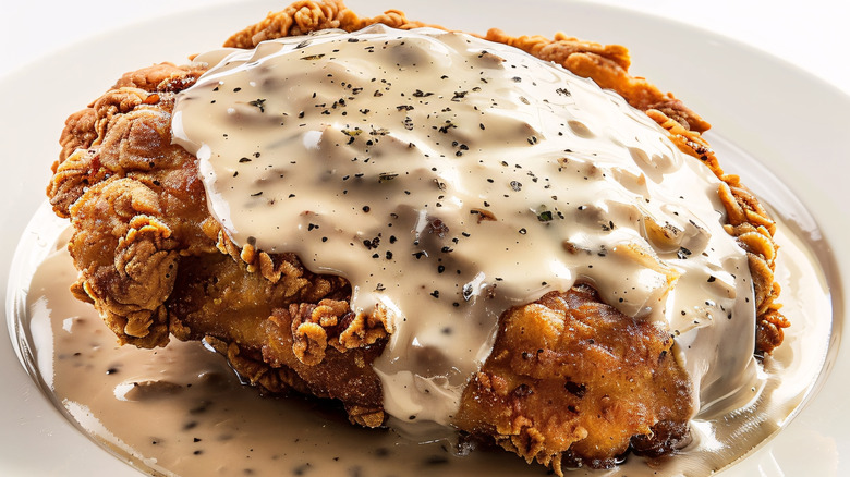 Battered and fried chicken fried steak covered in cream gravy