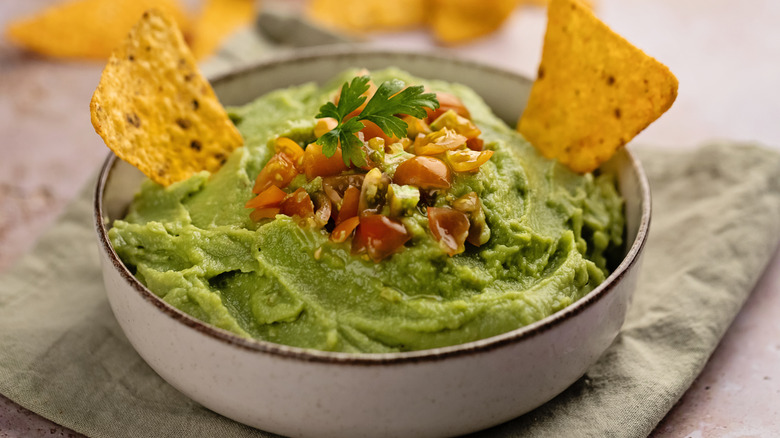 Bowl of guacamole with chips to dip