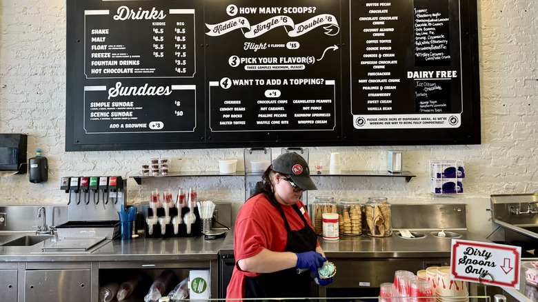 Employee working behind the counter of Clumpies Ice Cream Co. in Chattanooga, Tennessee