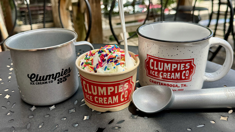 Clumpies ice cream, ice cream scoop, and mugs sit outside the North Shore location of the ice cream parlor in Chattanooga, Tennessee
