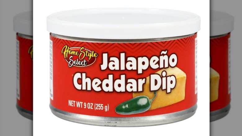 A can of Homestyle Select jalapeño cheddar dip on a white background.