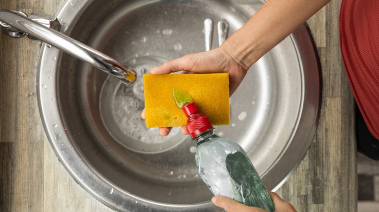 overhead shot of squeezing detergent onto sponge