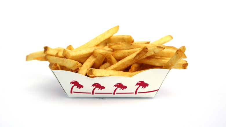 French fries in cardboard boat with red palm trees