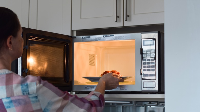 Putting food in microwave