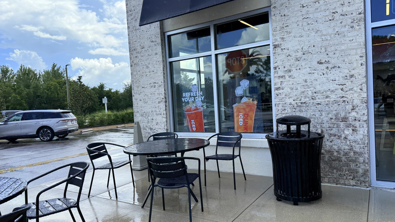 window stickers on outside of Dunkin' advertising Dunkin' Refreshers drinks