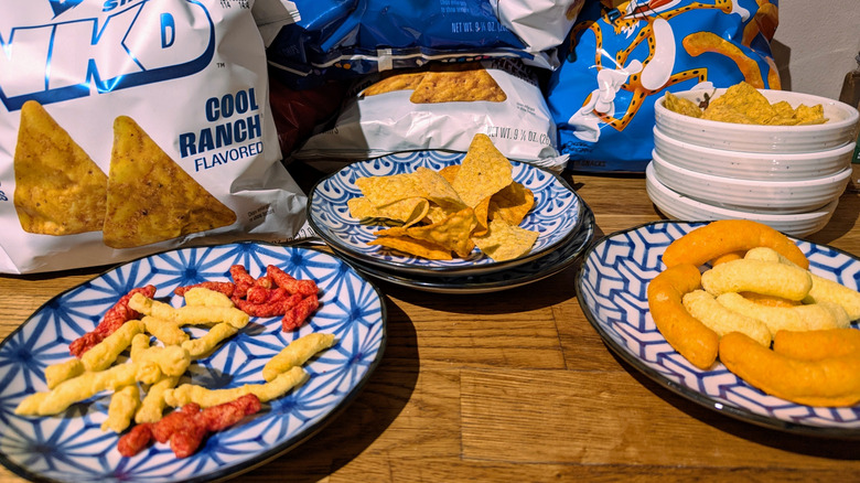 all simply nkd snacks mixed with regular frito lay snacks in bowls and plates