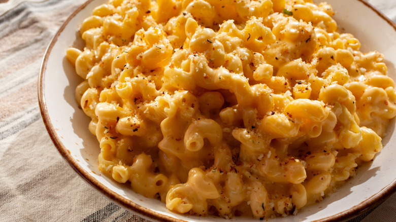 A bowl of mac and cheese topped with breadcrumbs