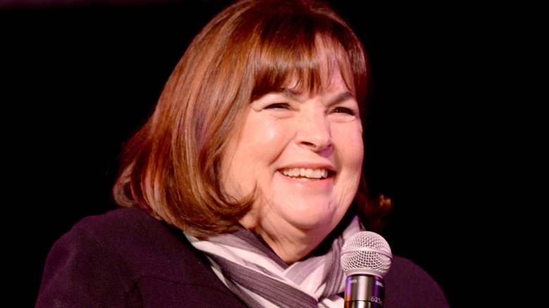 Ina Garten speaking onstage holding microphone