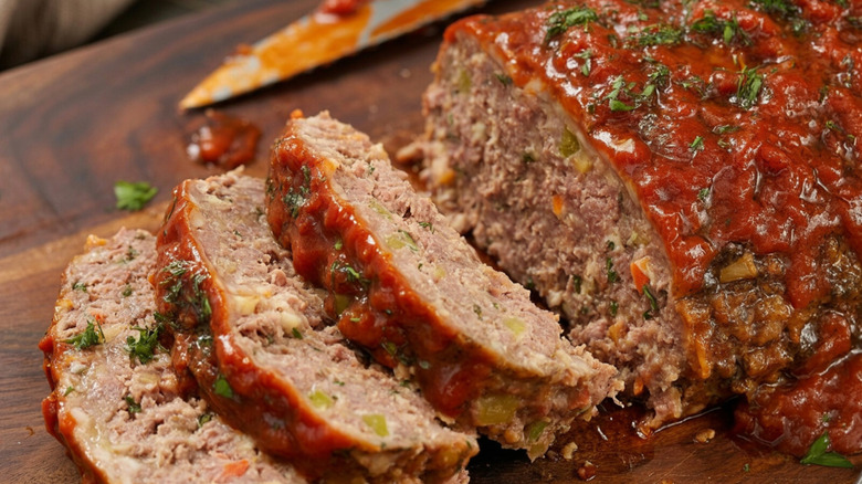 Top view of meatloaf sliced on a wooden cutting board
