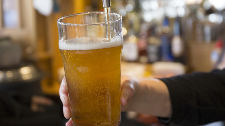 Bartender serving beer in a pub