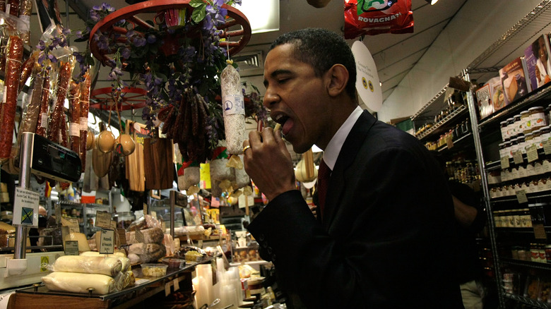 Democratic presidential hopeful U.S. Sen. Barack Obama (D-IL) tastes a piece of cheese April 2, 2008 as he visits the Italian Market section of Philadelphia, Pennsylvania.