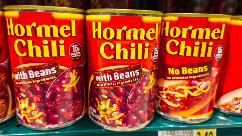 cans of Hormel chili on a store shelf