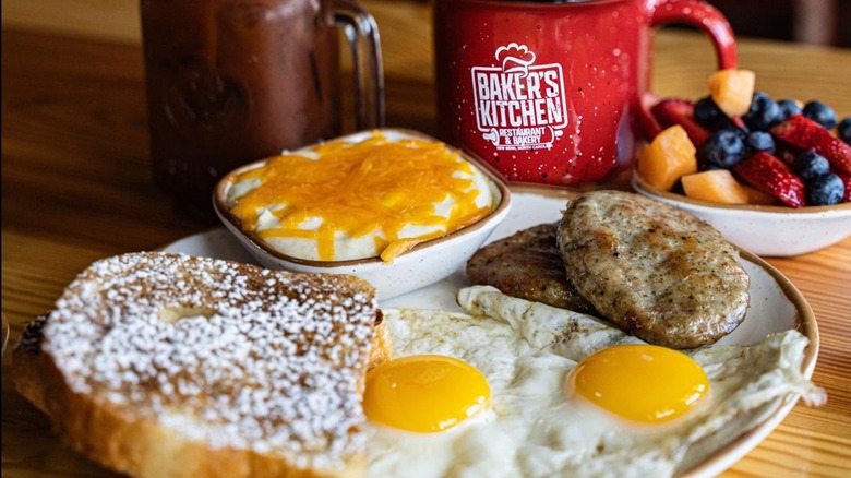 Breakfast spread including sausage patties, fried eggs, fresh fruit and French Toast at Baker's Kitchen.