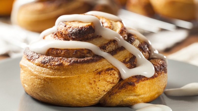 Close-up of a cinnamon roll with icing on it.