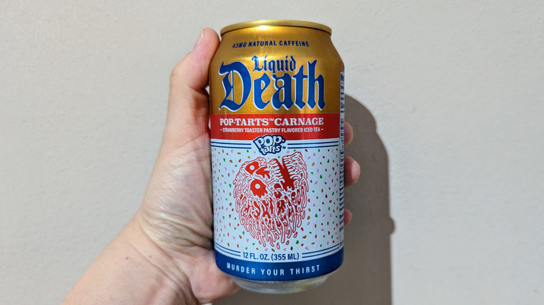 Hand holding Liquid Death Pop-Tarts Carnage can