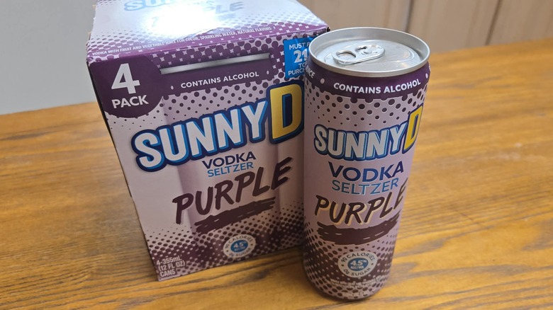 Can of SunnyD Purple Vodka Seltzer can next to a box of it