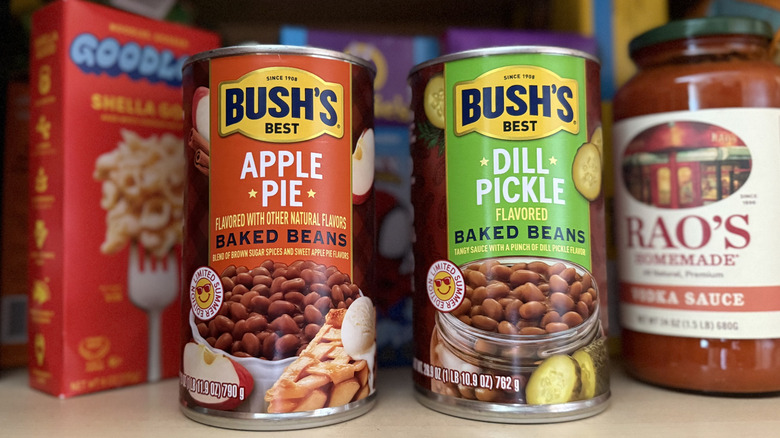 Cans of Bush's Best Apple Pie and Dill Pickle