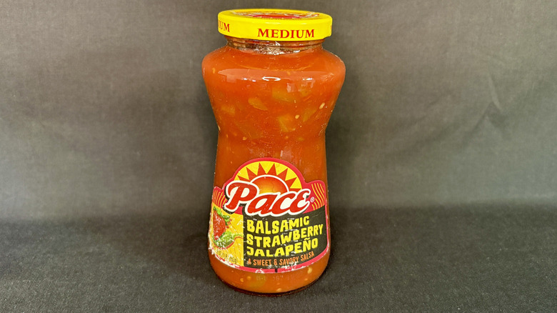 Jar of Pace salsa on black background