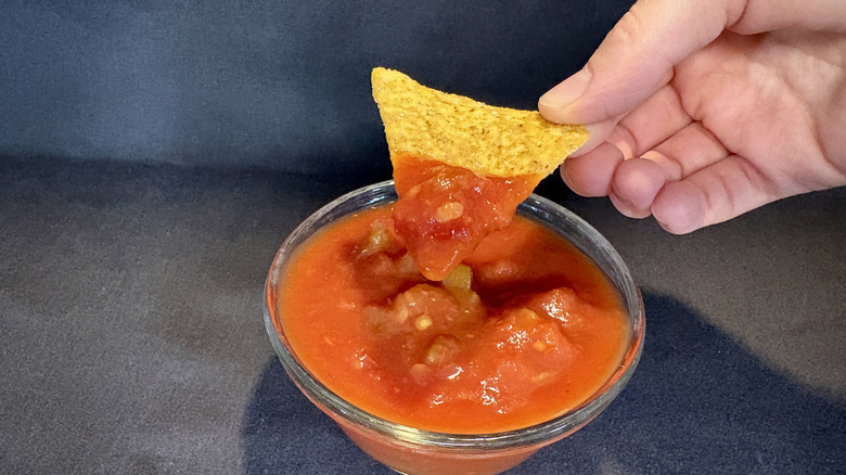 Late July chip dipped into Pace salsa