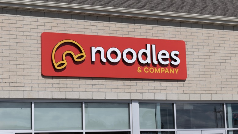 The sign on the outside of a Noodles & Company restaurant.