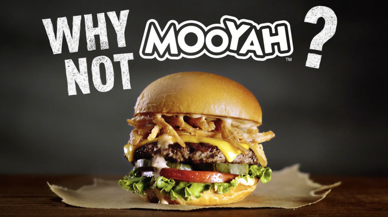 Screenshot of Mooyah commercial featuring burger with fried onions.