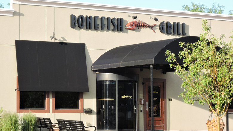 Exterior of Bonefish Grill building featuring sign on top of door.
