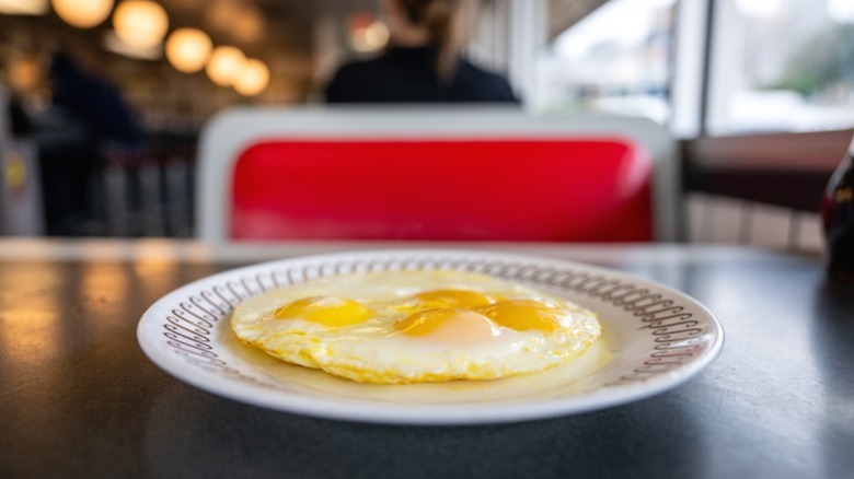 A plate of eggs overeasy at a Waffle House.
