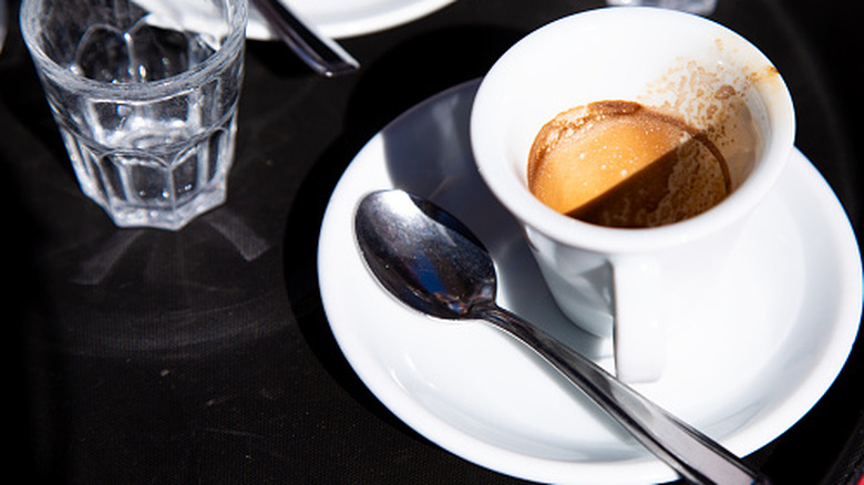White cup and saucer of espresso