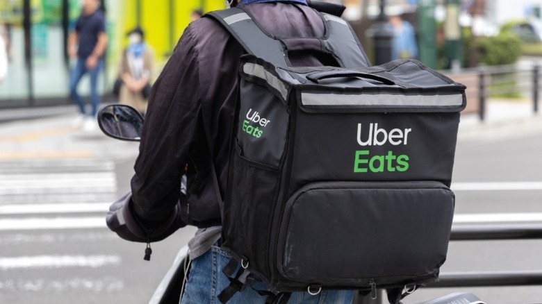 An Uber Eats delivery driver on a bike.