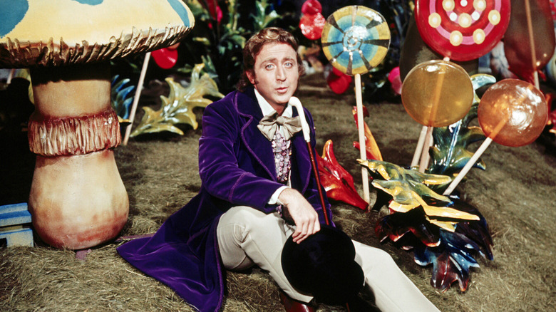 Gene Wilder as Willy Wonka surrounded by giant colorful candies