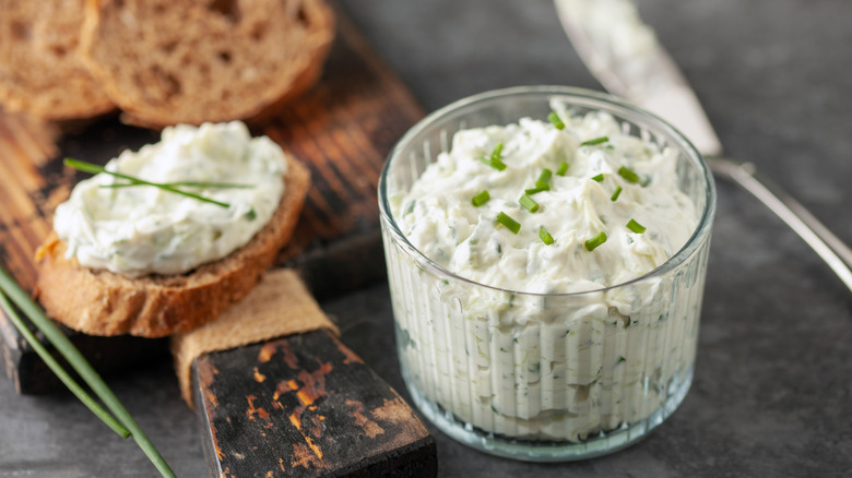 A bowl of benedictine spread and sliced bread
