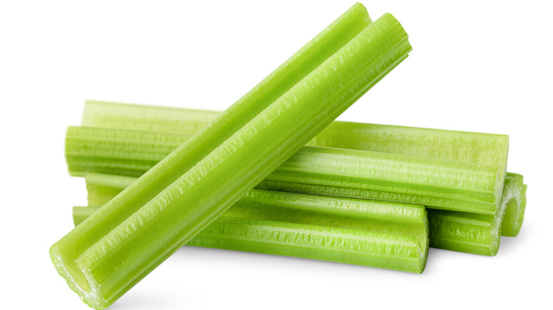 Chopped celery stalks on a white background