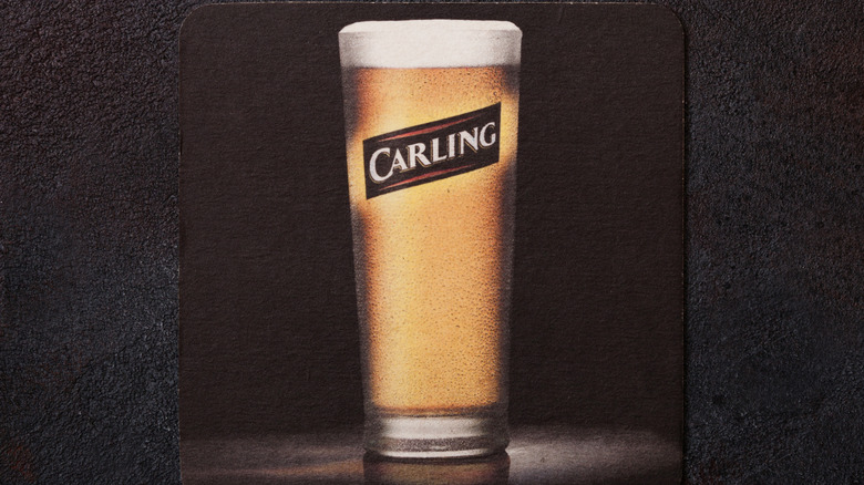 A Carling coaster on a black background