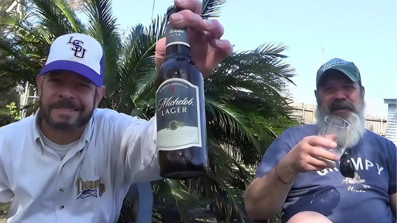 Two men enjoying Michelo Original Lager Beer outside