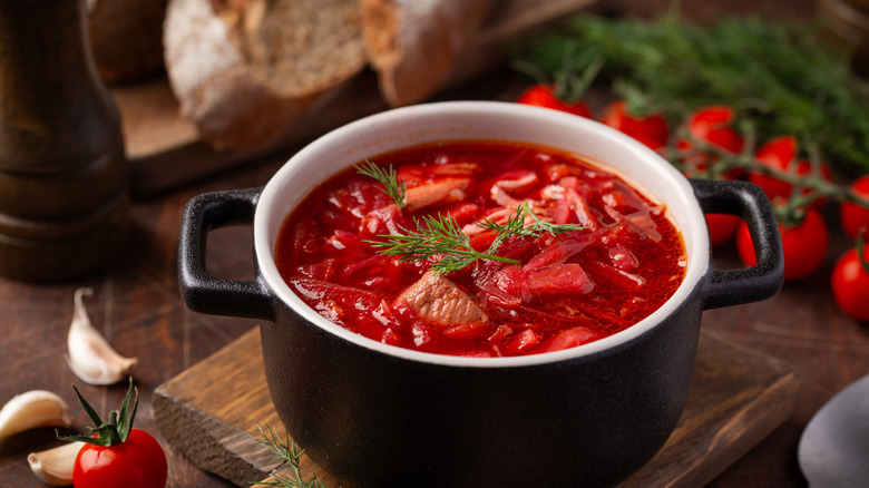 Borscht soup in a black bowl