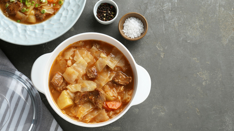 Cabbage and beef soup in a white bowl