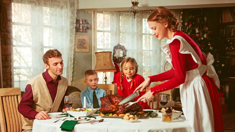 Family having a holiday dinner together in a '50s retro style