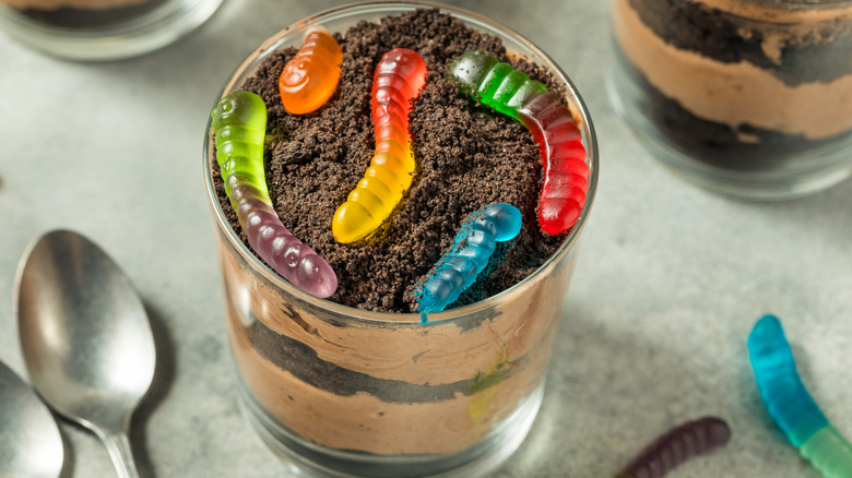 A cup of dirt pudding with gummy worms