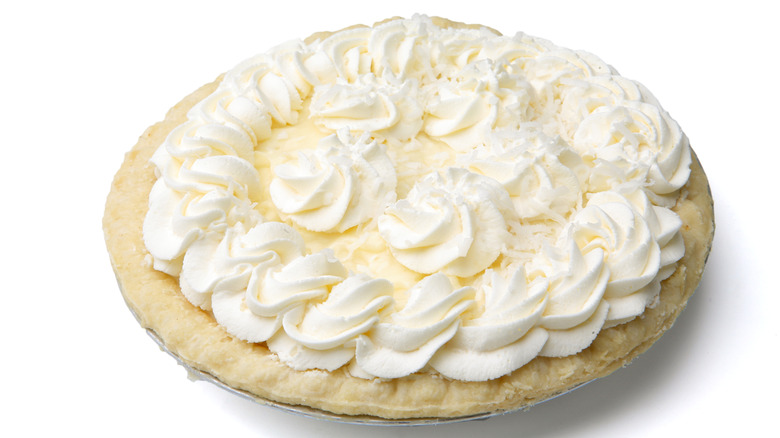 Whipped cream-tipped pie on a white background