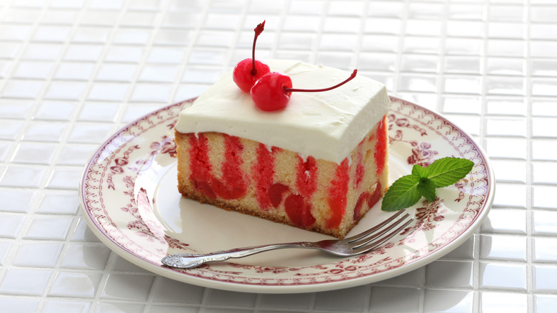 Strawberry poke cake on a vintage plate