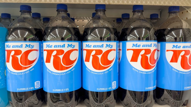 Several bottles of RC Cola on a store shelf