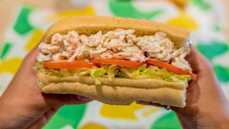 Hands holding Subway Seafood Sensation